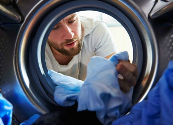 Man checking clothes in dryer